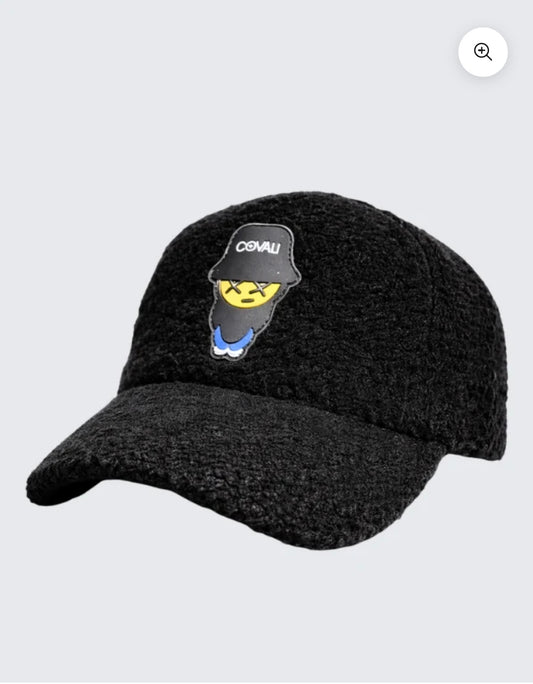 Black knit cap with embroidered design on a light gray background